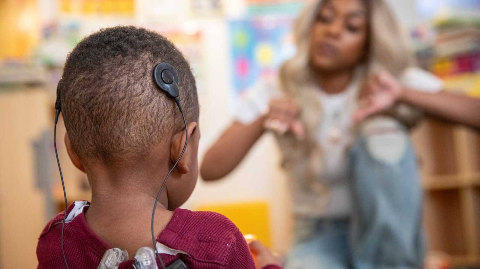 Grace and daughter Jane with hearing device